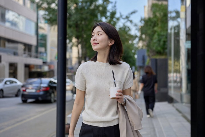 A candid Korean woman walking through a quiet Gangnam side street