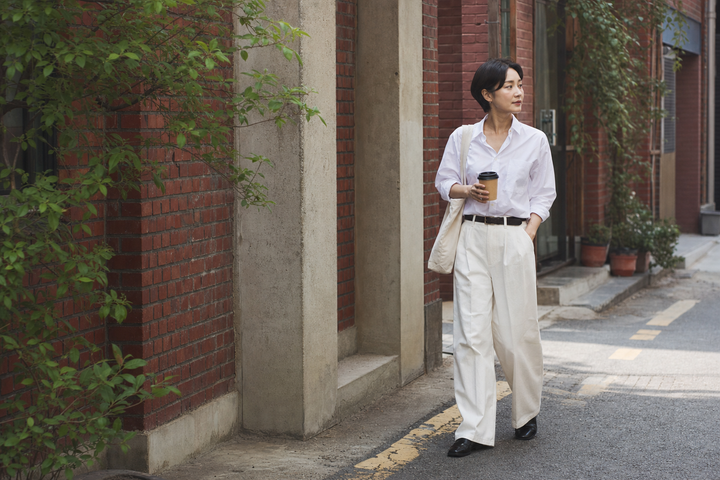 A Korean creative professional walking through Seongsu-dong in the morning